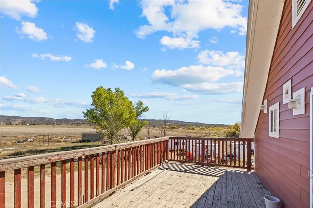 a view of a balcony with wooden floor