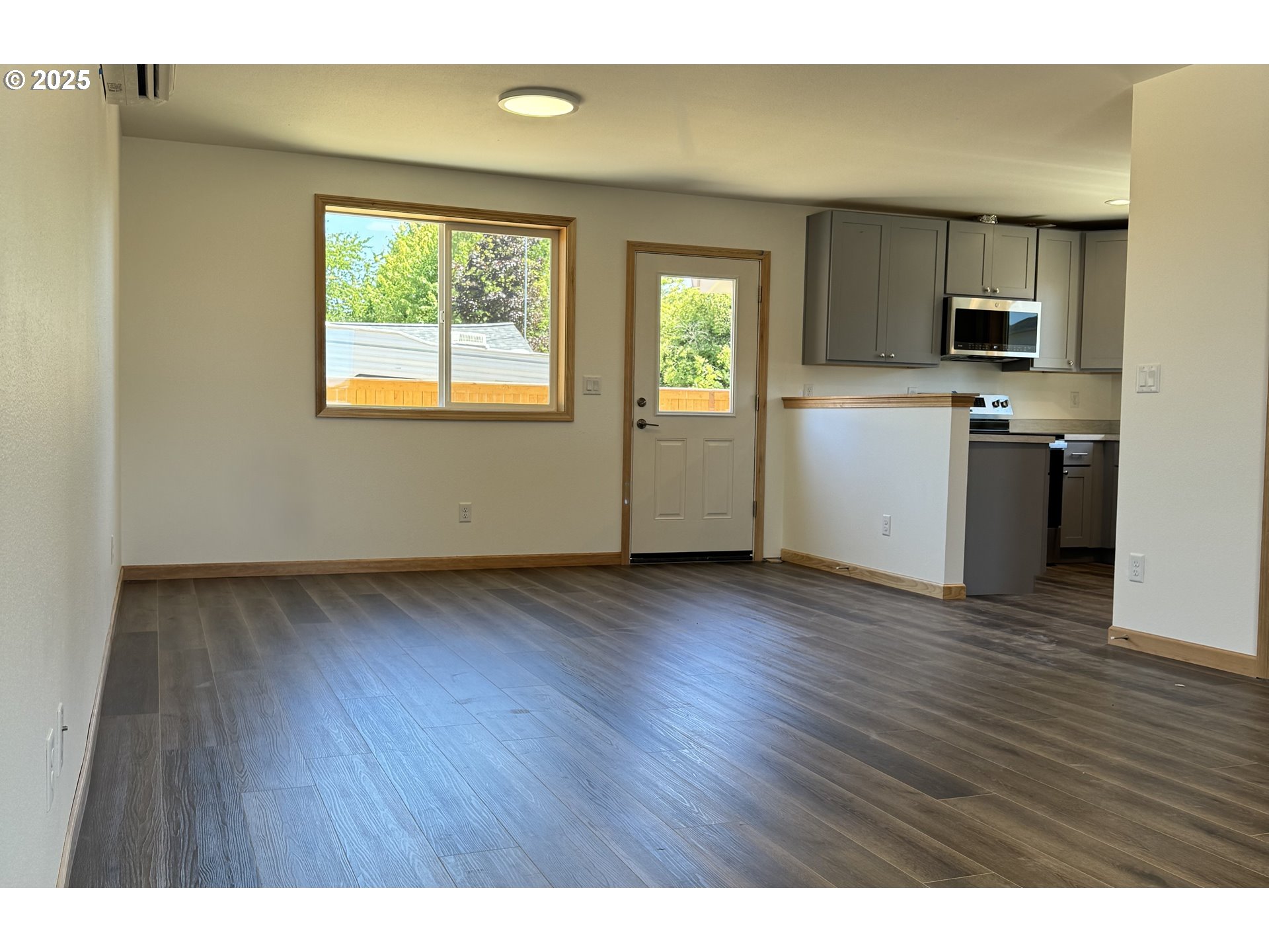650 ST Charles Street Eugene, OR 97402 - Photo 2 of 17 a view of a kitchen with wooden floor electronic appliances and windows
