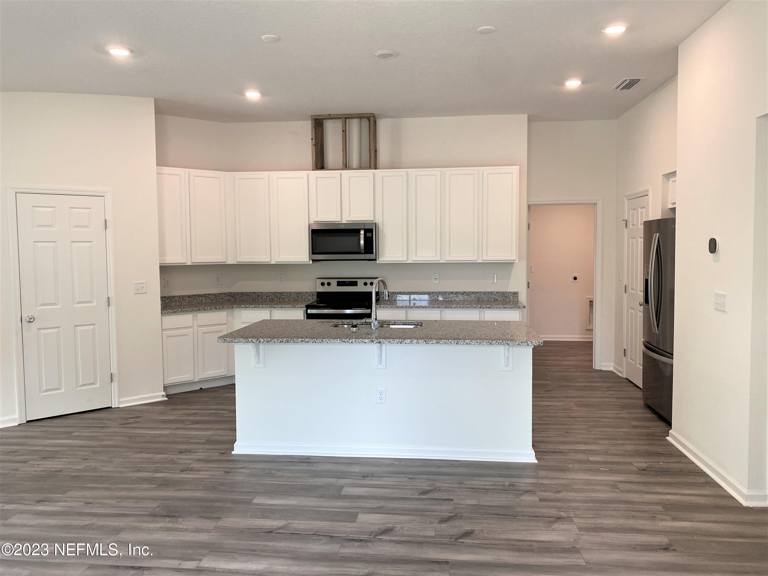 11611 Double Eagle Court Jacksonville, FL 32221 - Photo 2 of 9 a large kitchen with stainless steel appliances a refrigerator and a stove top oven