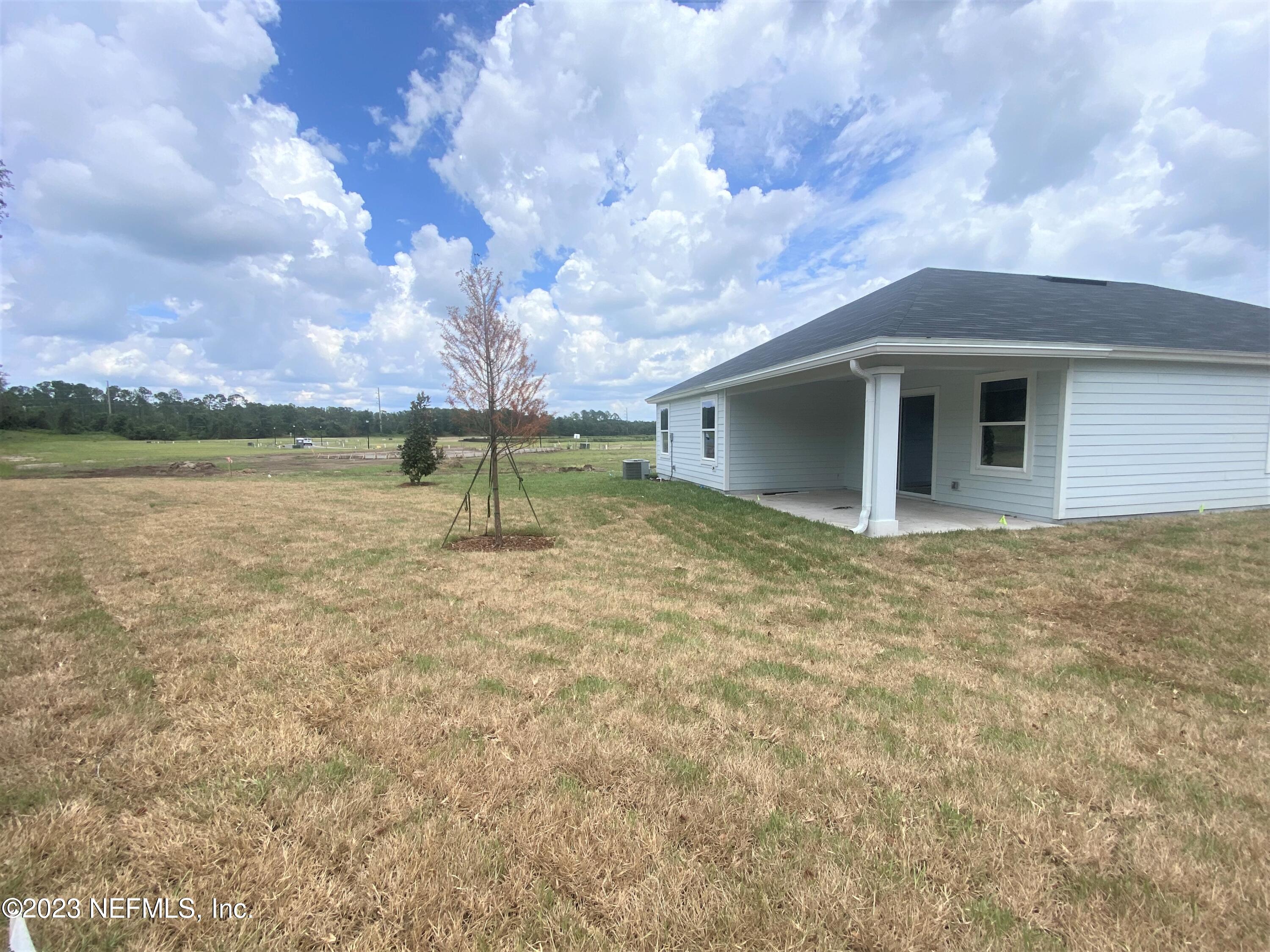 11611 Double Eagle Court Jacksonville, FL 32221 - Photo 6 of 9 a backyard of a house with table and chairs