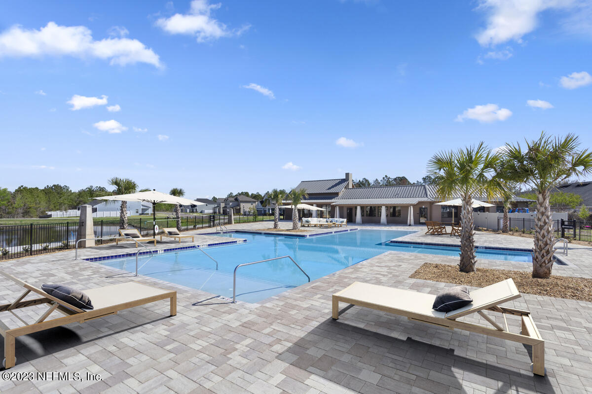 11611 Double Eagle Court Jacksonville, FL 32221 - Photo 7 of 9 a view of a swimming pool and lounge chairs