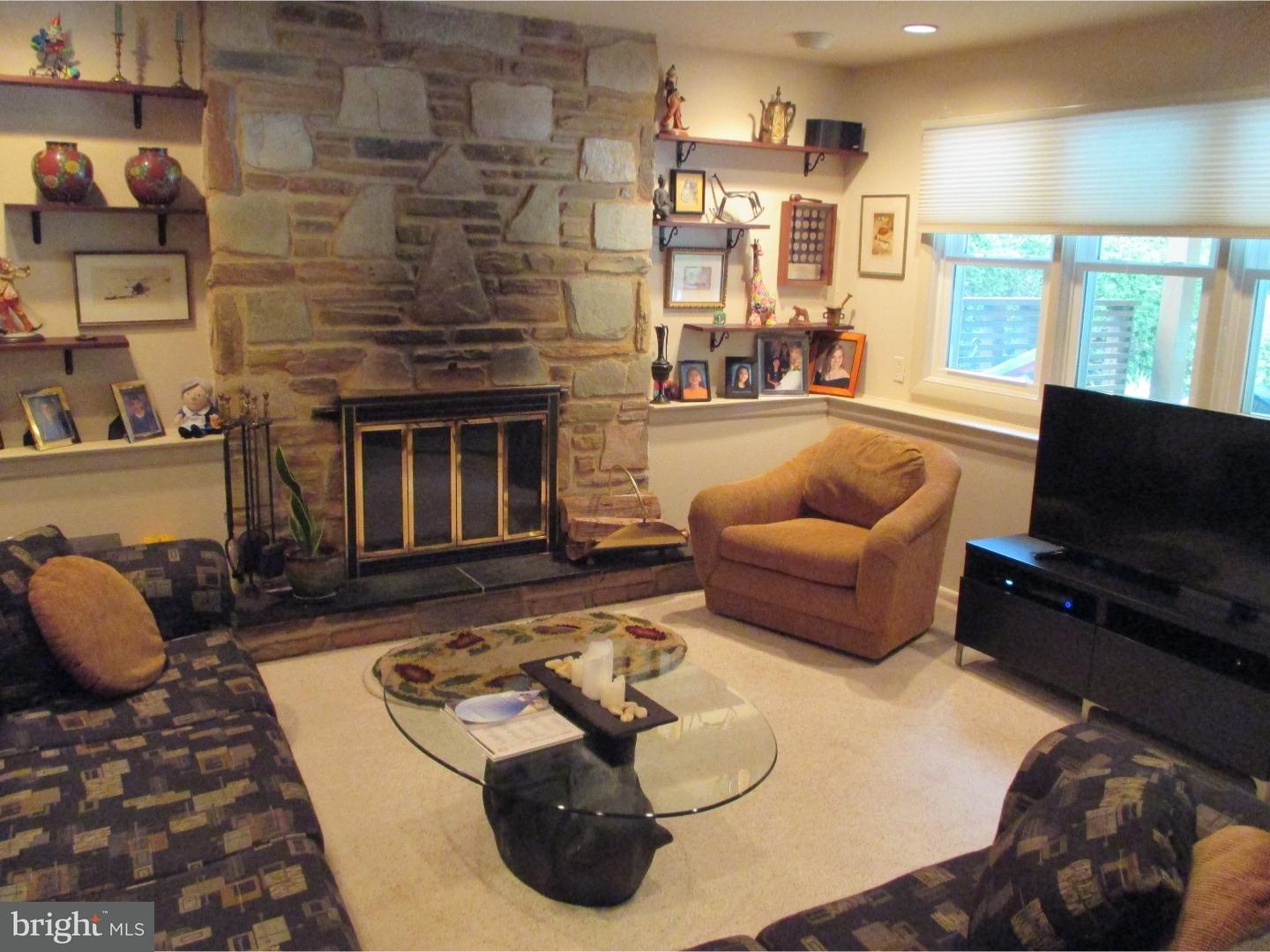 641 Kismet Road Philadelphia, PA 19115 - Photo 24 of 25 a living room with furniture and a fireplace