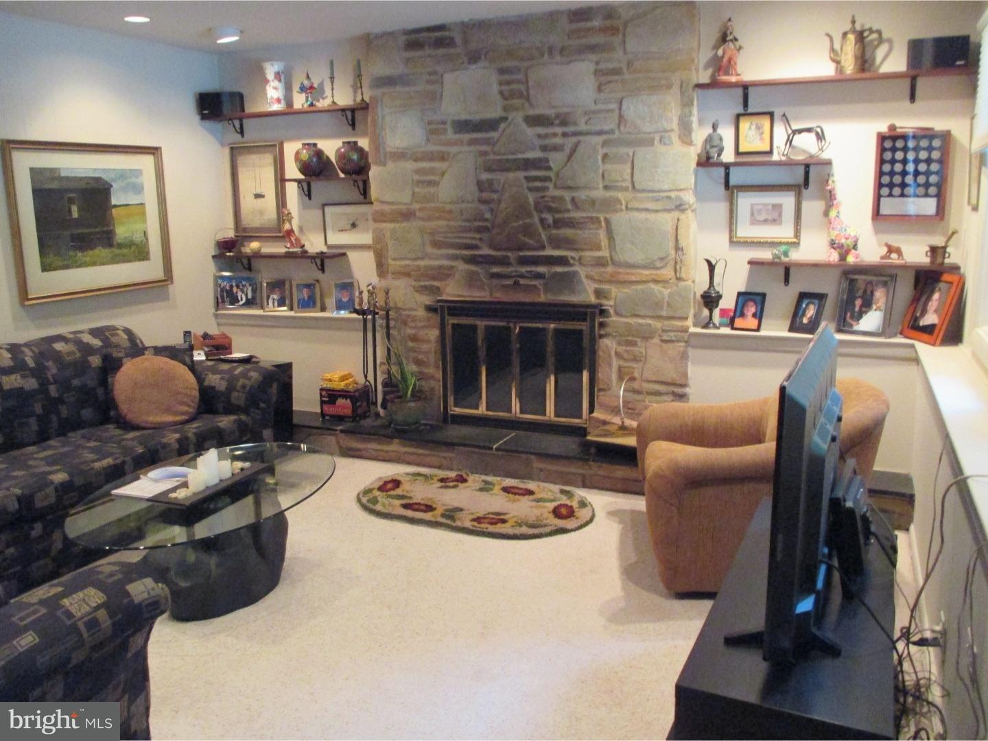 641 Kismet Road Philadelphia, PA 19115 - Photo 25 of 25 a living room with furniture and a fireplace