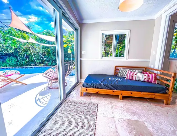 a bedroom with furniture and a large window