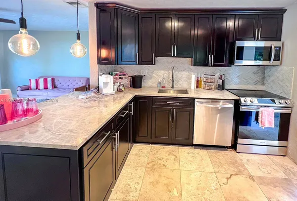 a kitchen with a sink stove and cabinets