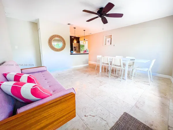 a living room with a bed and chandelier