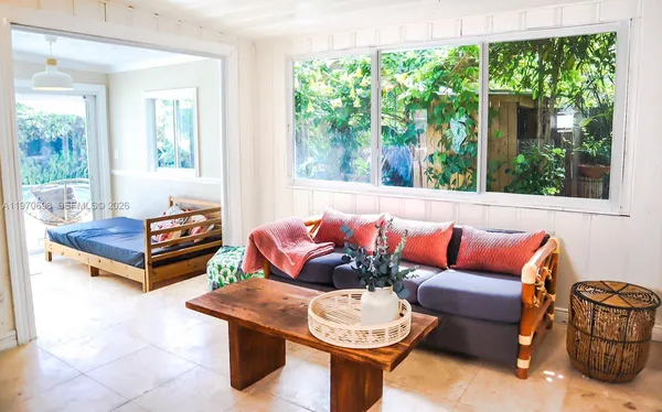 a living room with furniture and a potted plant