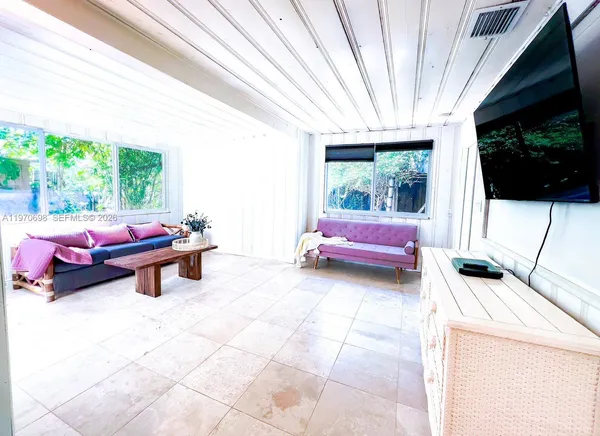 a bedroom with furniture and a flat screen tv