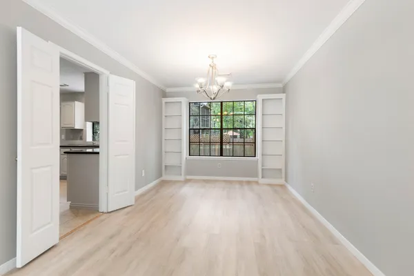 wooden floor in an empty room with a window