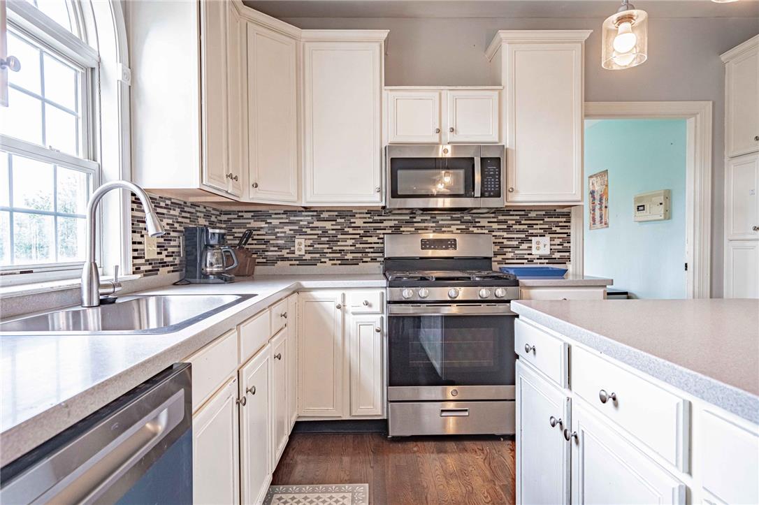 102 Sutton Road Easton, PA 18045 - Photo 25 of 83 Gleaming hardwood floors and classic cabinetry anchor this well-appointed culinary workspace.