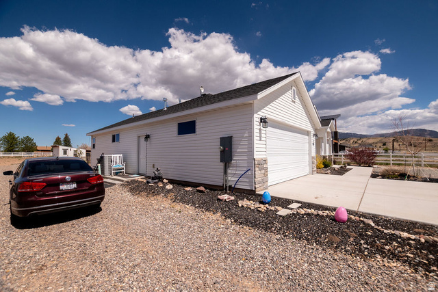 745 East 885 North Beaver, UT 84713 - Photo 5 of 50 View of home's exterior featuring driveway, a garage, and a mountain view