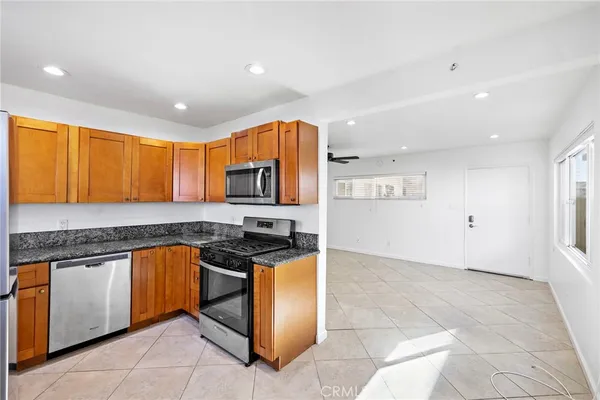 a kitchen with stainless steel appliances granite countertop a stove and a sink