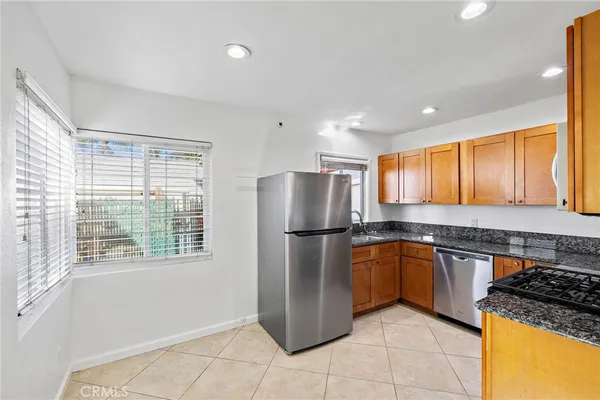 a kitchen with a refrigerator a sink and a stove
