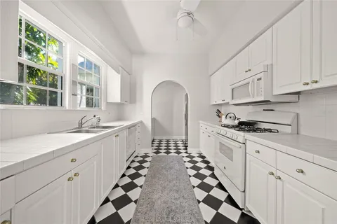 a kitchen with sink cabinets and window