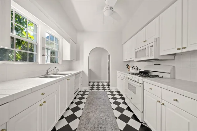 a kitchen with sink cabinets and window