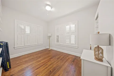 a empty room with window and wooden floor