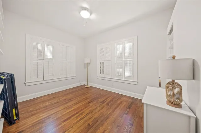 a empty room with window and wooden floor