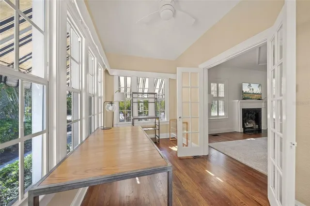 a view of a hallway with wooden floor and windows