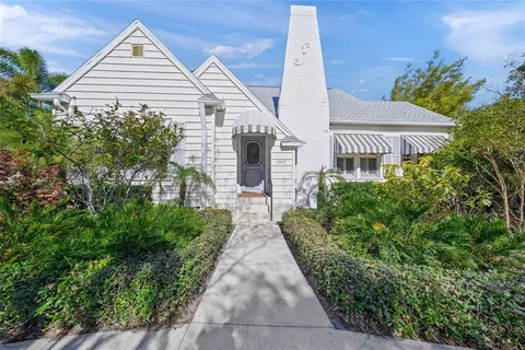 a view of a house with brick walls and plants