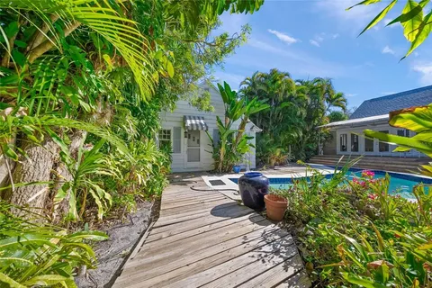 a view of a backyard with sitting area