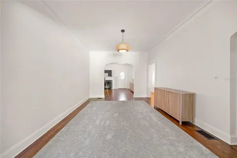 a view of a room with a ceiling fan and window
