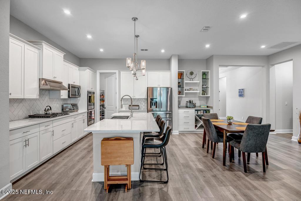 323 Glenneyre Circle St. Augustine, FL 32092 - Photo 11 of 53 a large kitchen with cabinets table and chairs