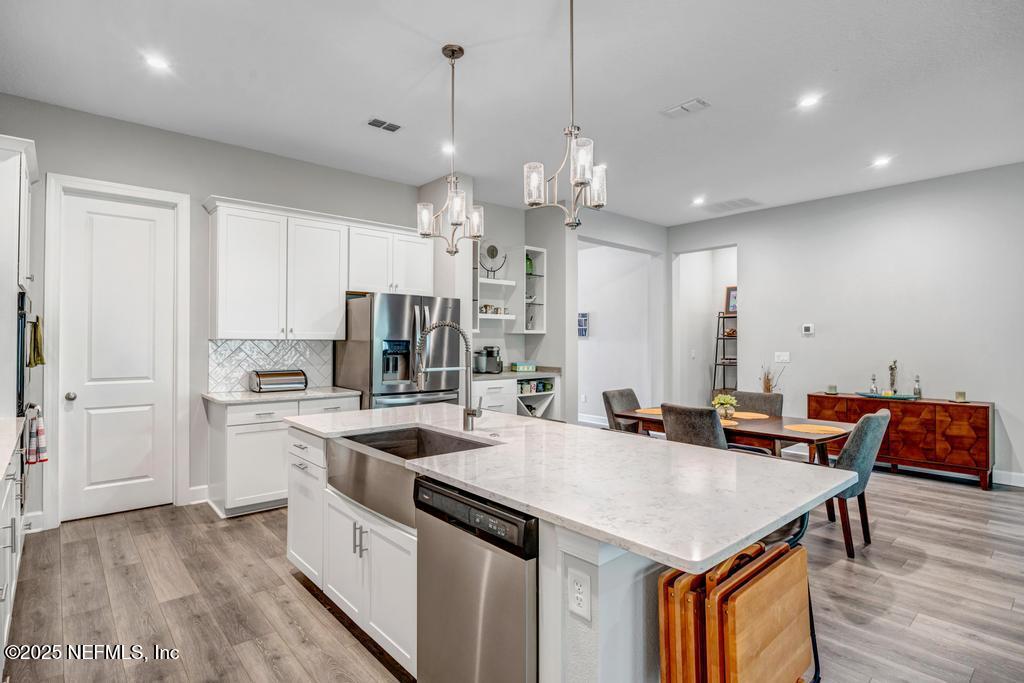 323 Glenneyre Circle St. Augustine, FL 32092 - Photo 13 of 53 a kitchen with stainless steel appliances granite countertop a sink a stove and a refrigerator