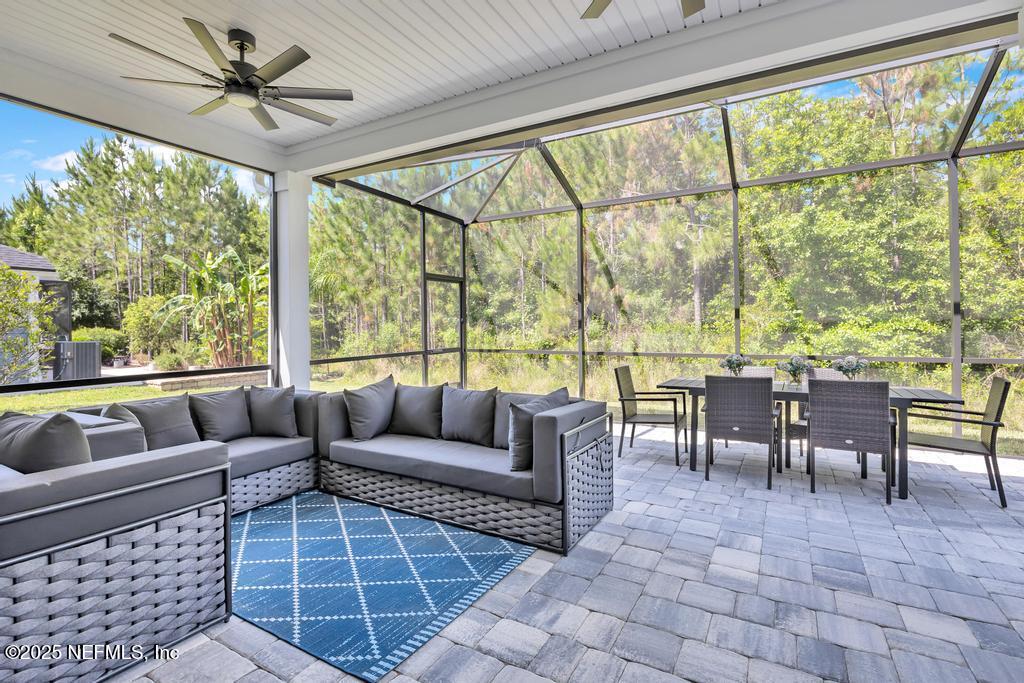 323 Glenneyre Circle St. Augustine, FL 32092 - Photo 44 of 53 a living room with furniture and a large window with garden view