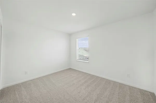 a view of an empty room and a window
