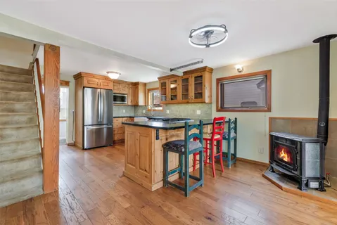 a kitchen with wooden floors and sink