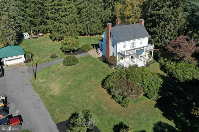 an aerial view of a house with a yard basket ball court and outdoor seating
