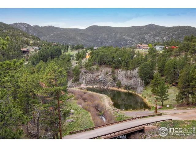 a view of a field with mountains in the background