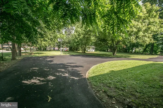 a view of an empty room with wooden floor and closet