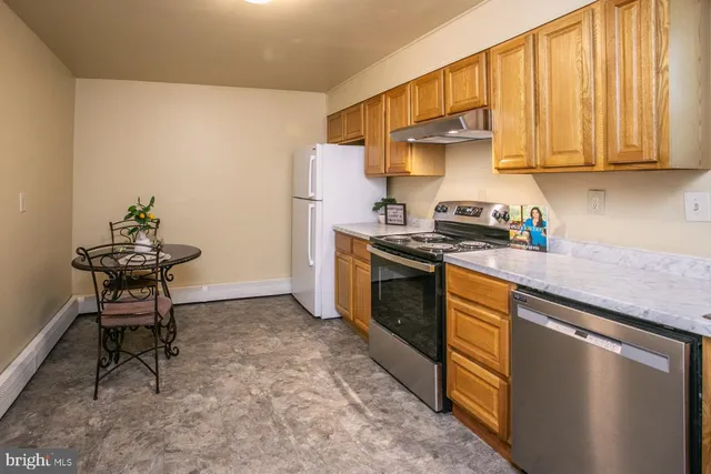 a kitchen with a stove sink and refrigerator