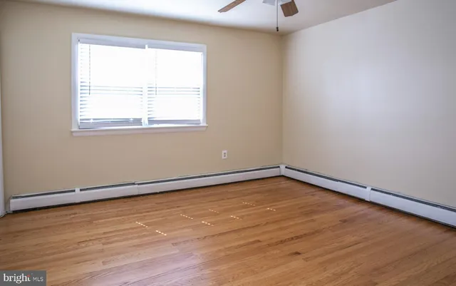 a view of a room with wooden floor and a window