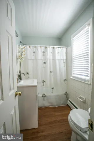 a bathroom with a sink vanity granite and shower