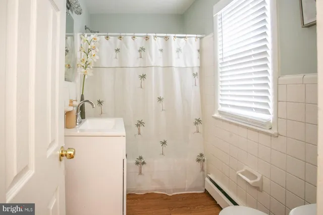 a white toilet sitting next to a bathroom sink and a shower