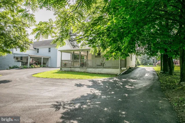 a view of a room with wooden floor and iron stairs