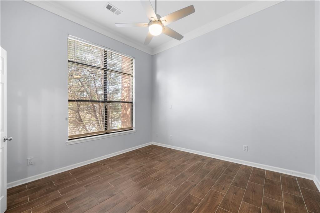 400 17th Street Northwest, Unit 1113 Atlanta, GA 30363 - Photo 16 of 22 an empty room with wooden floor and windows