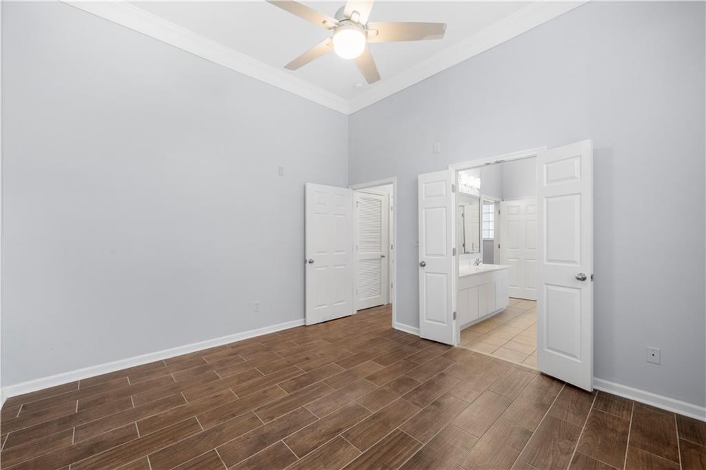 400 17th Street Northwest, Unit 1113 Atlanta, GA 30363 - Photo 18 of 22 a view of a kitchen with wooden floor and a ceiling fan