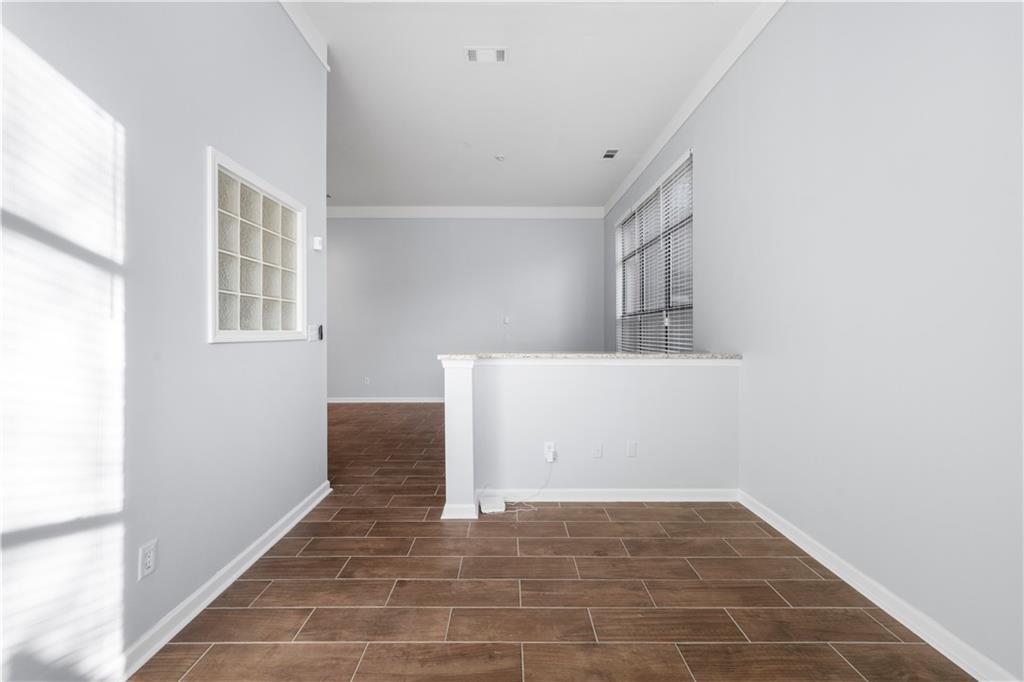 400 17th Street Northwest, Unit 1113 Atlanta, GA 30363 - Photo 22 of 22 a view of an empty room with wooden floor and a window