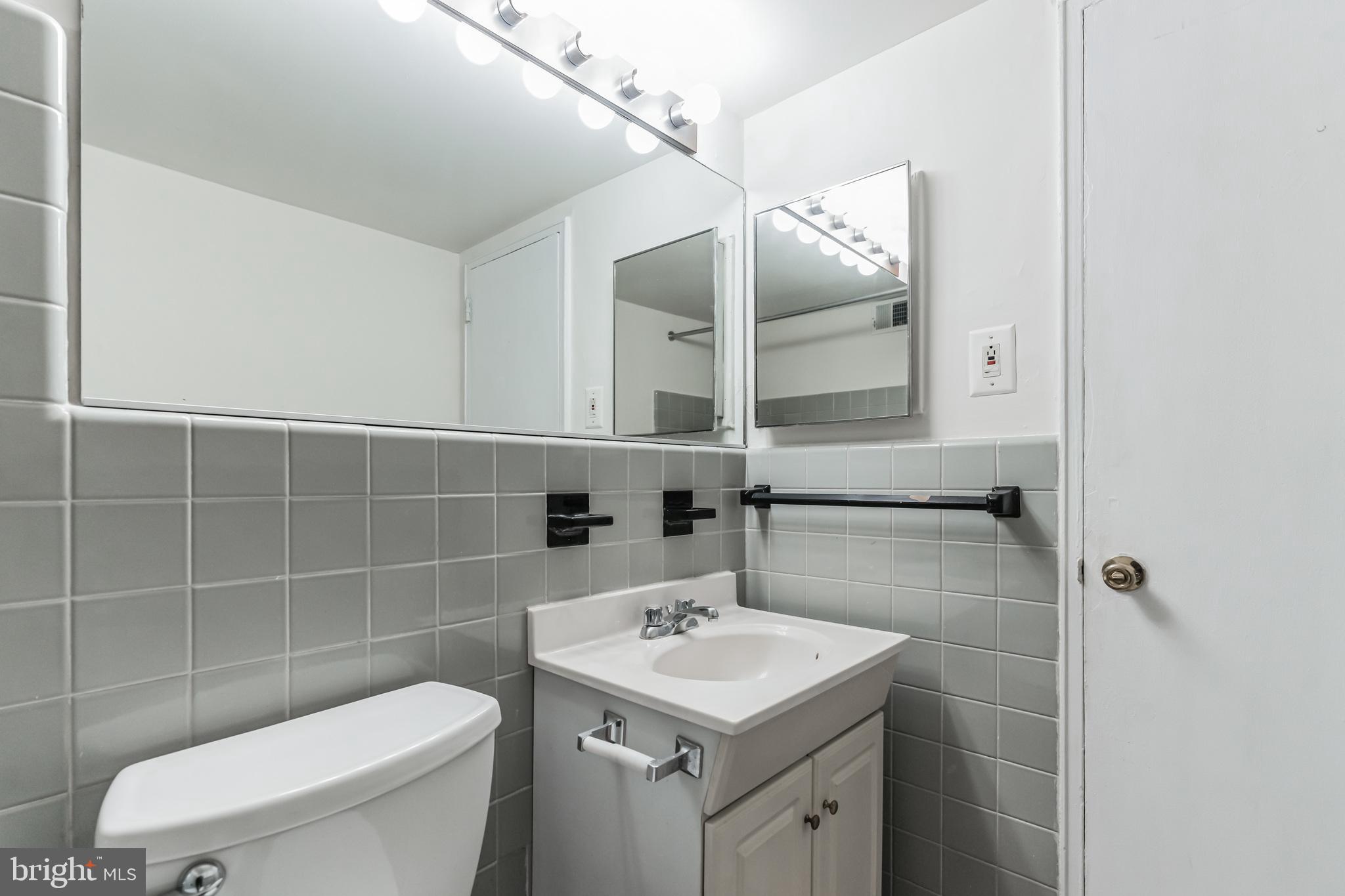 2101 Chestnut Street, Unit 1102 Philadelphia, PA 19103 - Photo 8 of 17 a bathroom with a sink toilet and mirror