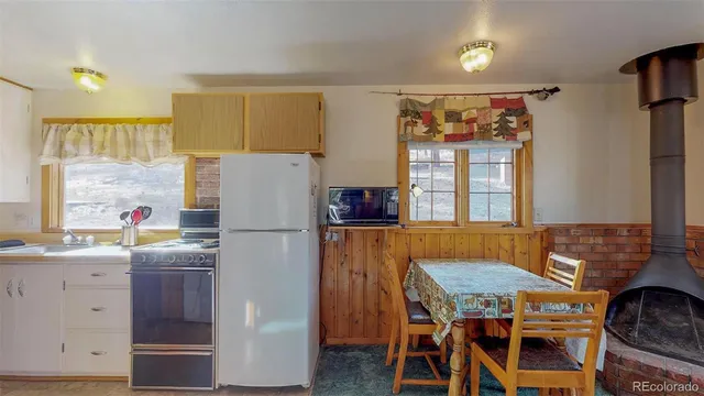 a kitchen with stainless steel appliances granite countertop a refrigerator and a stove