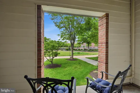 a view of a chairs and table in patio with a yard