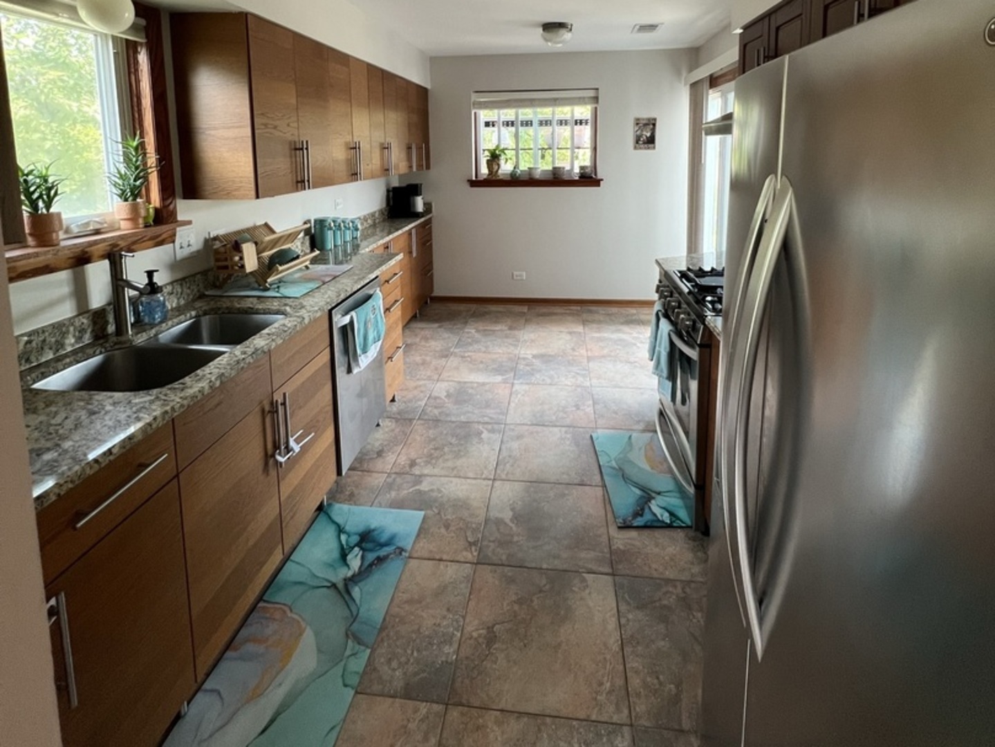1230 Chalet Road, Unit 204 Naperville, IL 60563 - Photo 6 of 17 a kitchen with stainless steel appliances granite countertop a refrigerator a stove a sink and a window