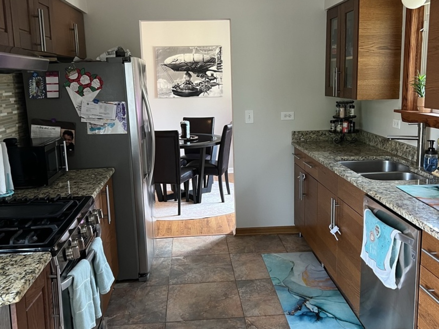 1230 Chalet Road, Unit 204 Naperville, IL 60563 - Photo 7 of 17 a kitchen with stainless steel appliances granite countertop a sink stove and cabinets