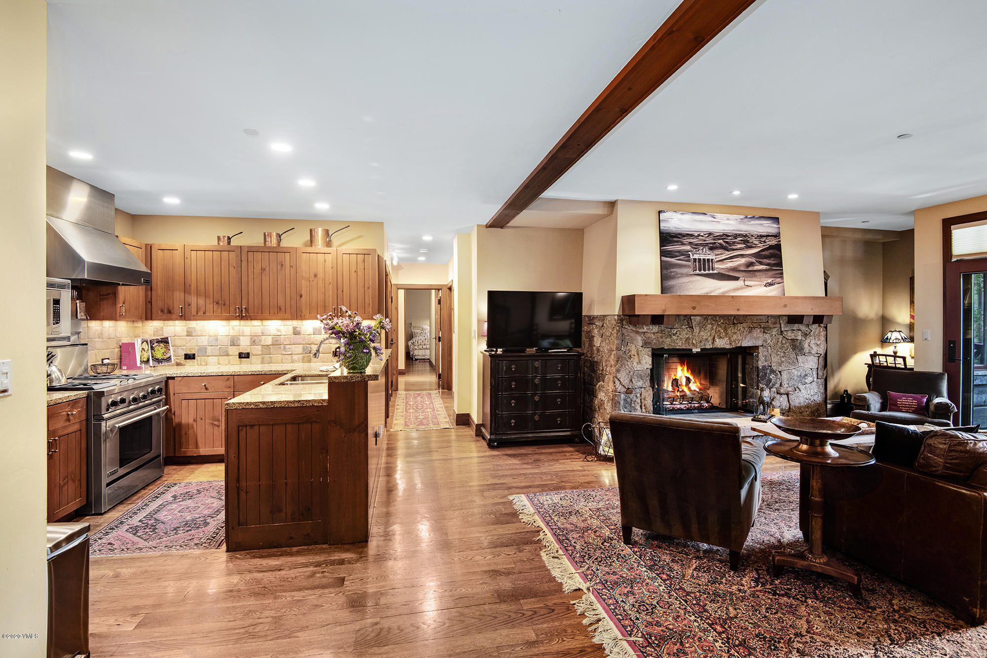 180 Daybreak Ridge Road, Unit 409 Avon, CO 81620 - Photo 13 of 47 a living room with furniture a fireplace and kitchen view