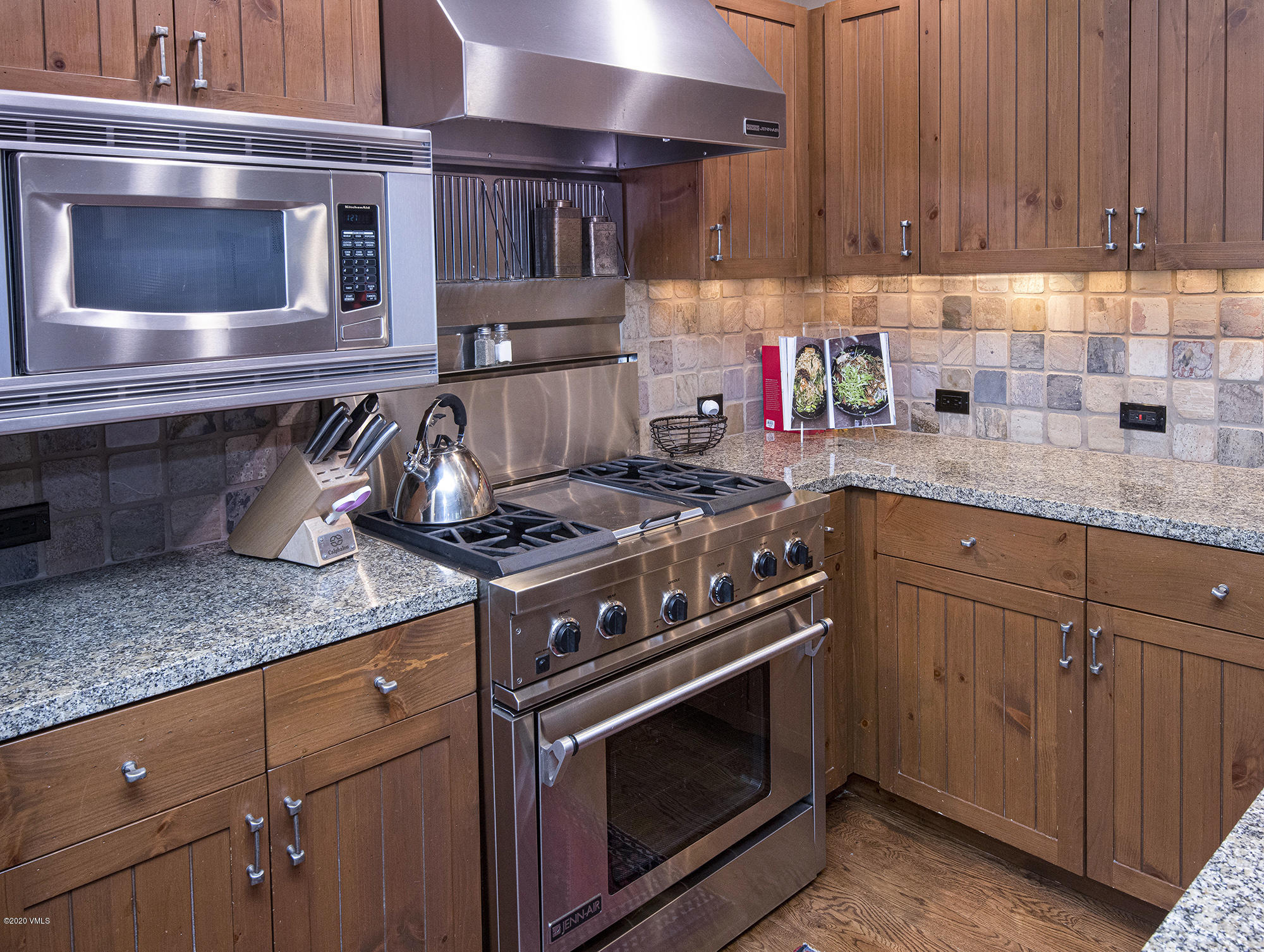180 Daybreak Ridge Road, Unit 409 Avon, CO 81620 - Photo 15 of 47 a kitchen with stainless steel appliances granite countertop a stove and a microwave
