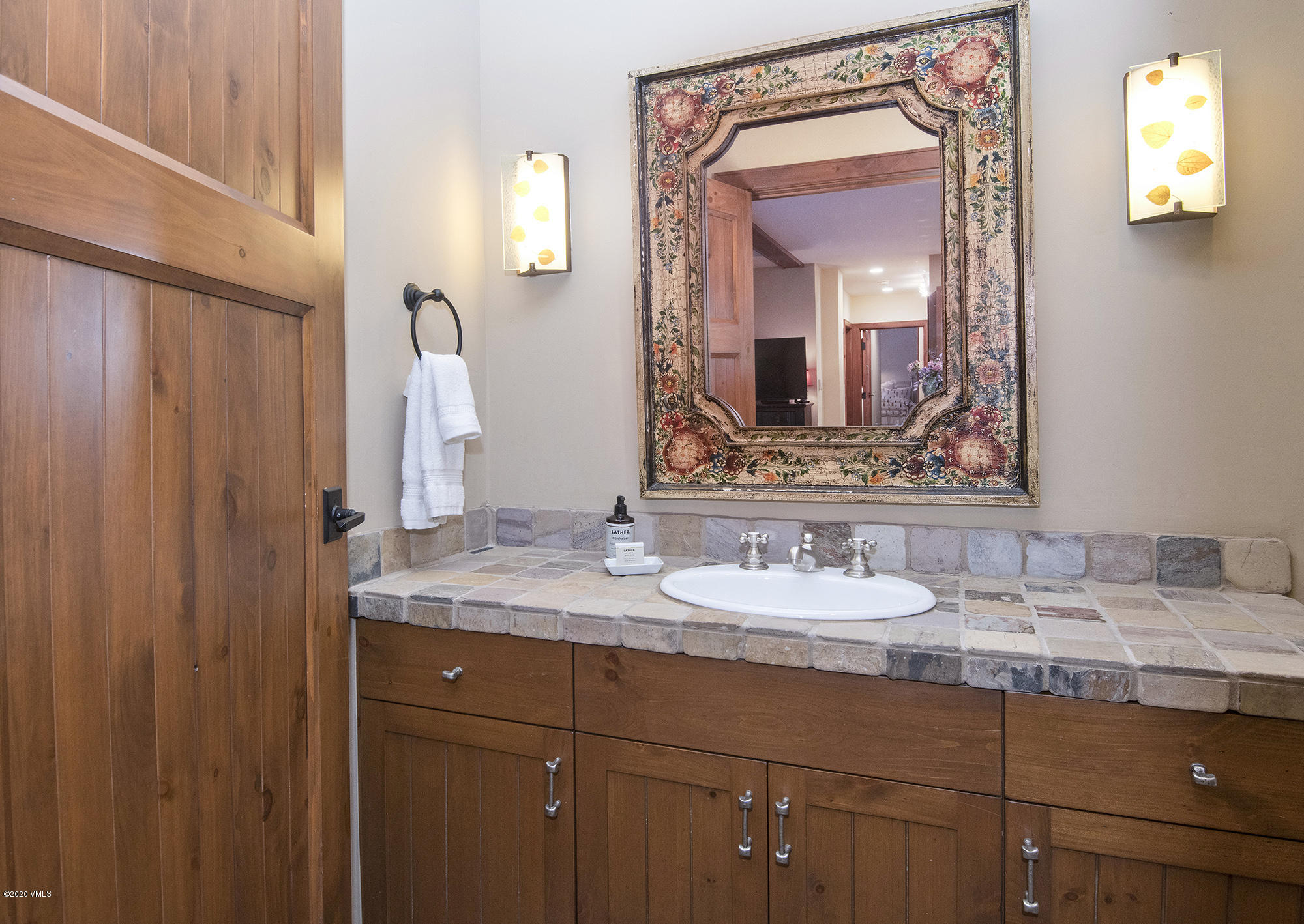 180 Daybreak Ridge Road, Unit 409 Avon, CO 81620 - Photo 16 of 47 a bathroom with a granite countertop sink and a mirror