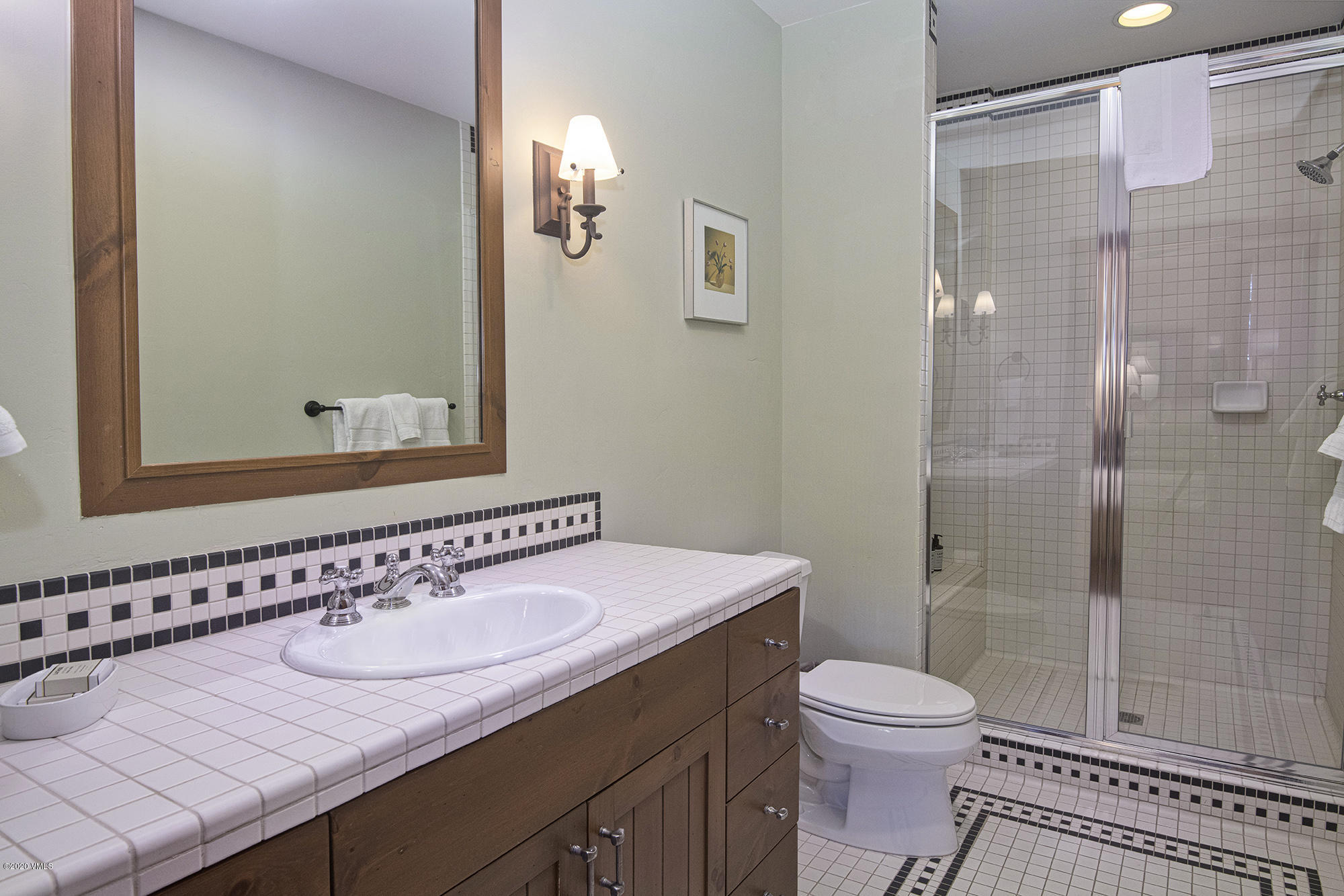 180 Daybreak Ridge Road, Unit 409 Avon, CO 81620 - Photo 18 of 47 a bathroom with a sink and a mirror